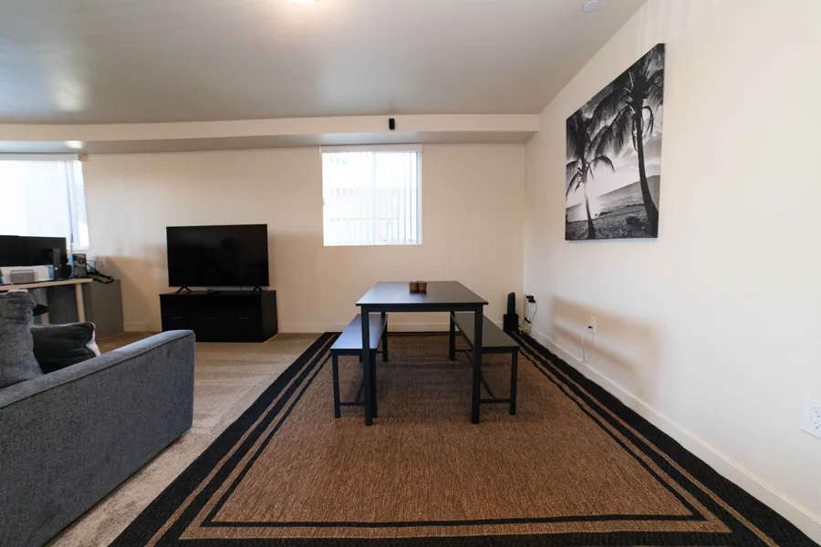 Dining table and bench seating in the common room of the East 54th Street shared housing home
