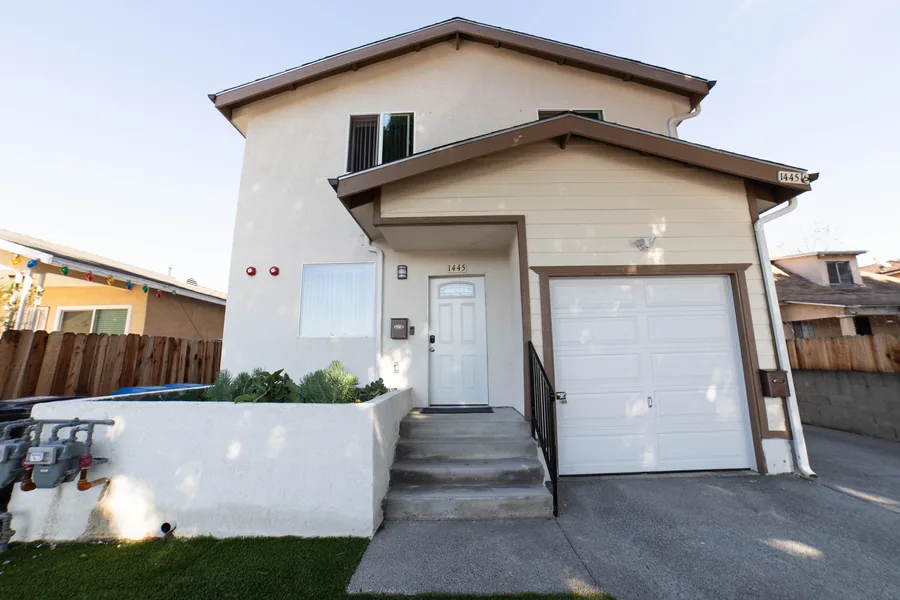 Entry steps and front door of the East 54th Street shared housing home in Los Angeles