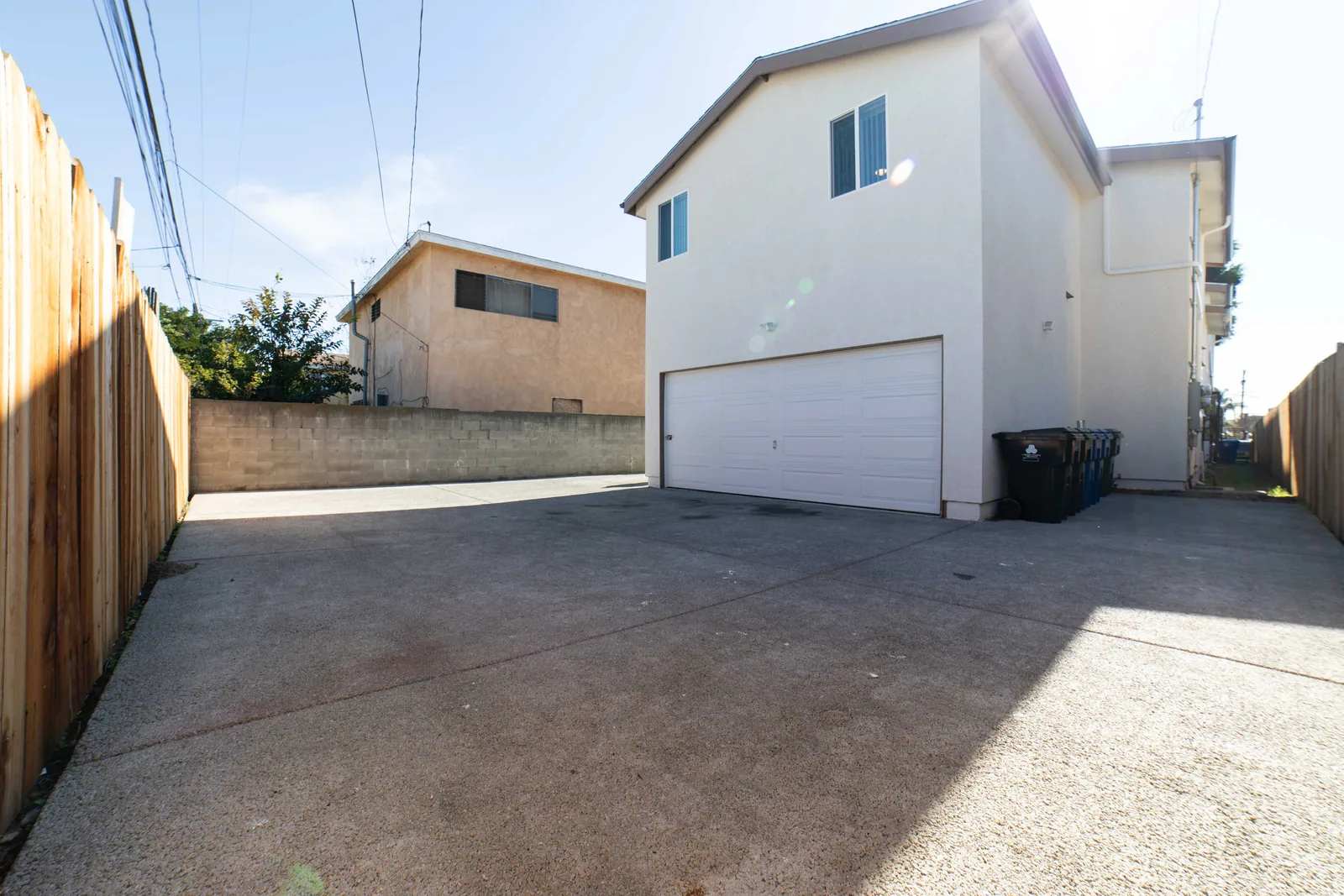 Paved rear yard and parking area behind the East 54th Street house in Los Angeles