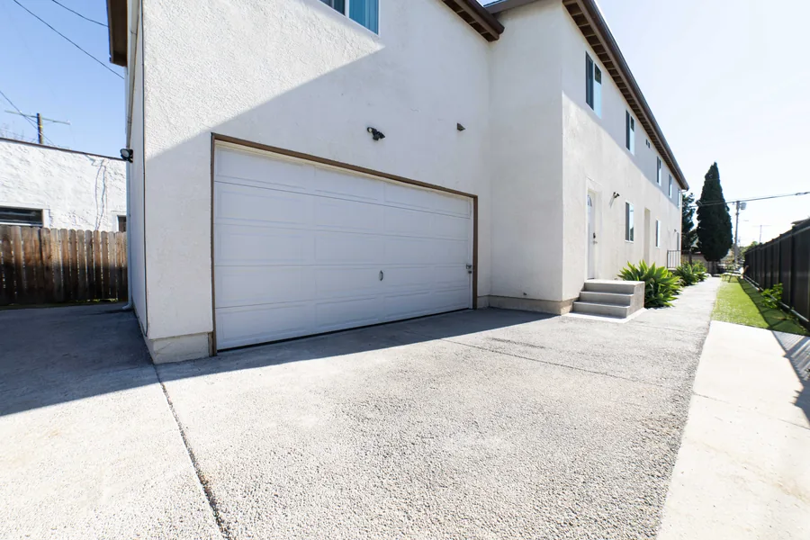 Side driveway garage and walkway along the West 42nd Street property in Los Angeles