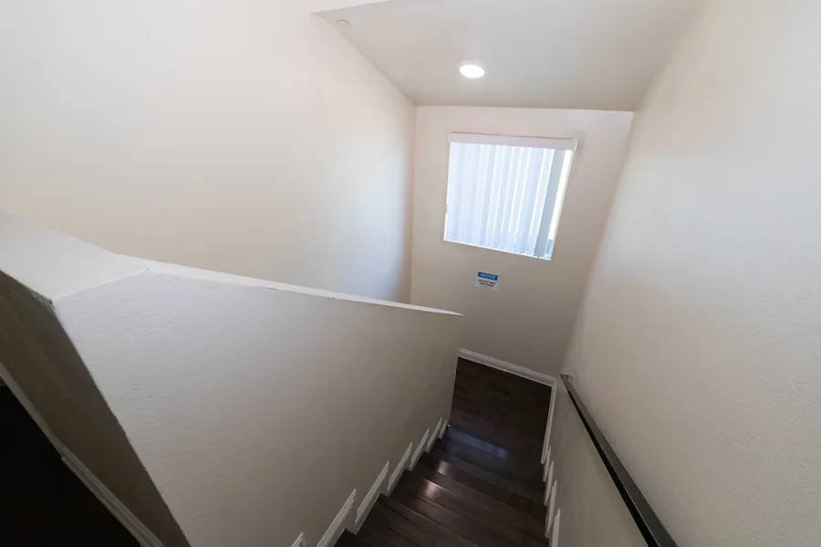 Staircase to the upper floor of the West 42nd Street shared housing home
