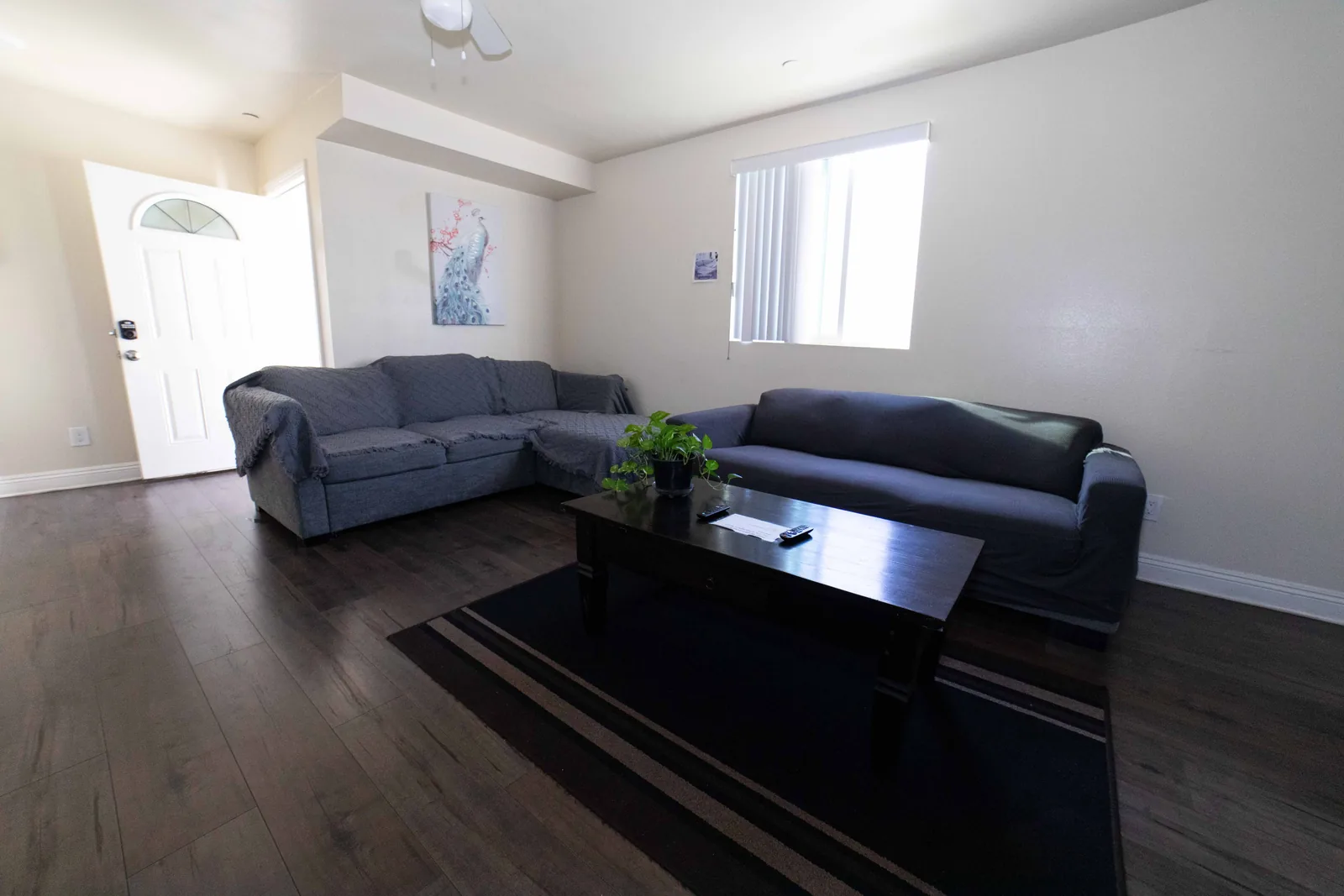 Wide view of the upper unit common room at the West 42nd Street house looking toward the front door