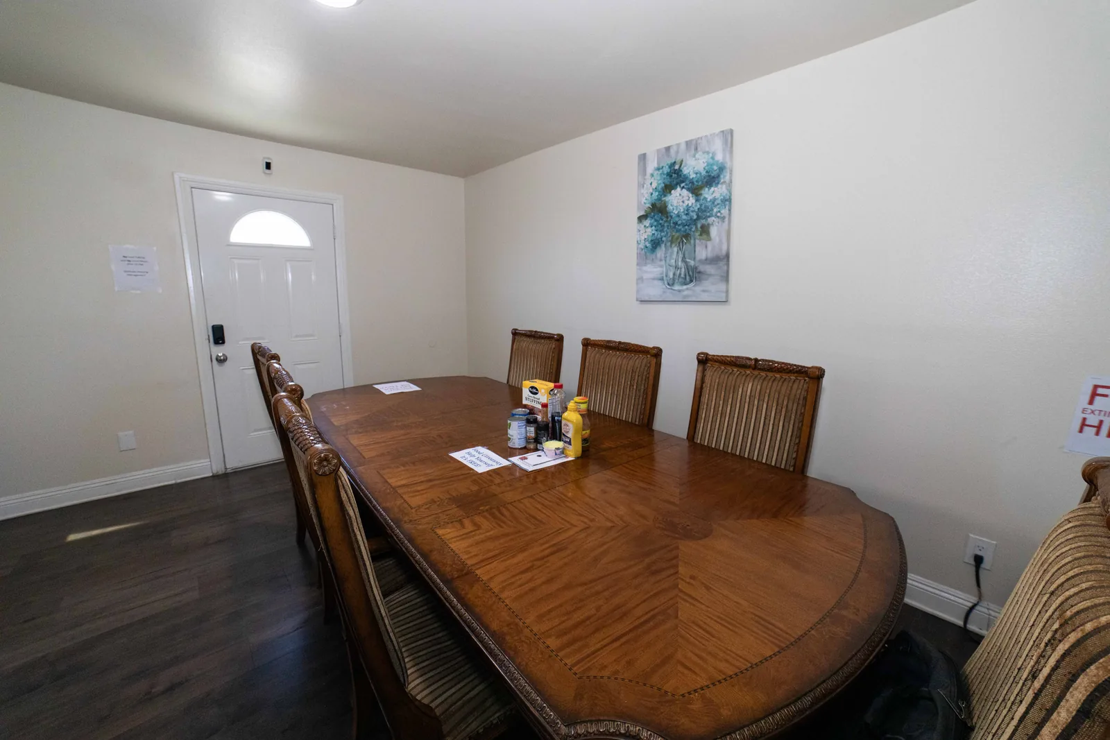 Dining area in the West 42nd Street upper unit with an oval wooden table and cane back chairs