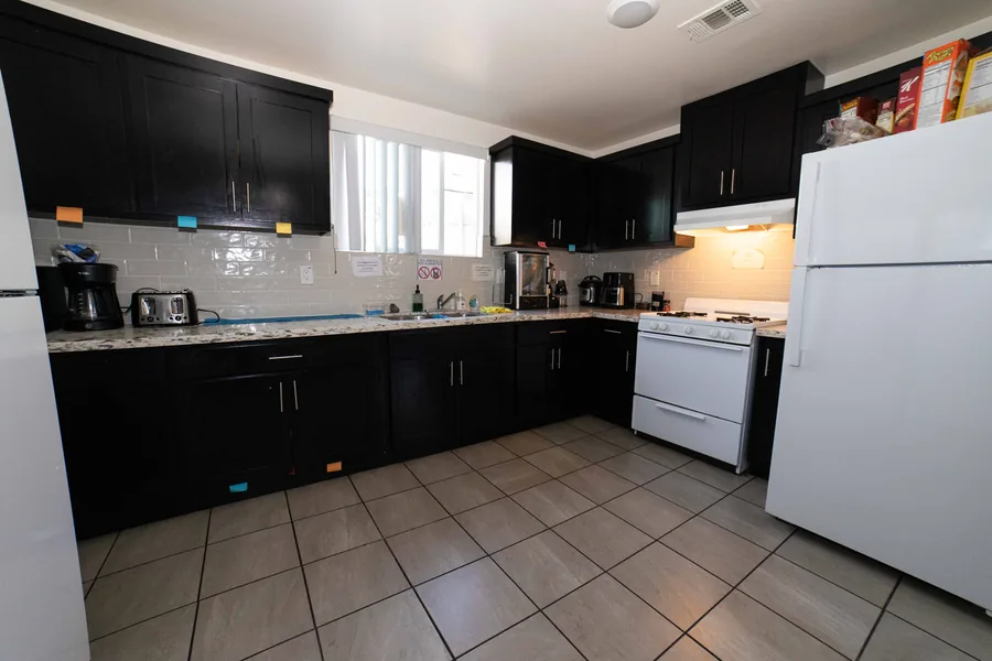 Counter run and gas range in the upper unit kitchen at the West 42nd Street house