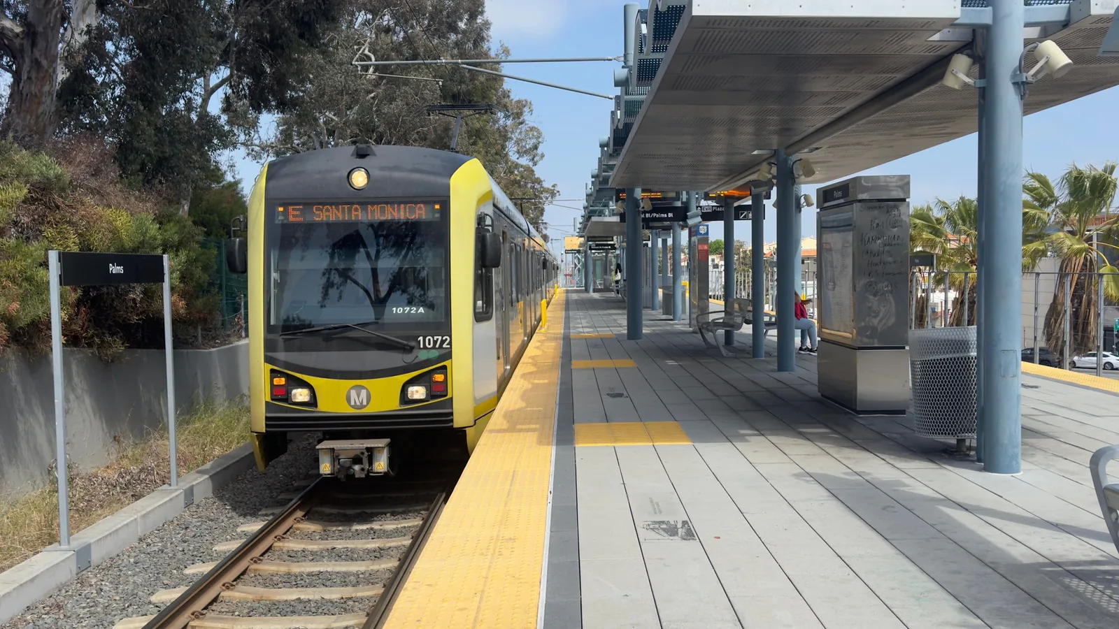 A Los Angeles Metro light rail train pulling into a station platform